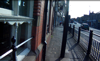 Picture of Gosforth High Street with a lamppost in the middle of the pavement