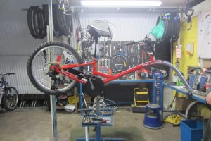 A tag-along bicycle waiting for repairs at Byker