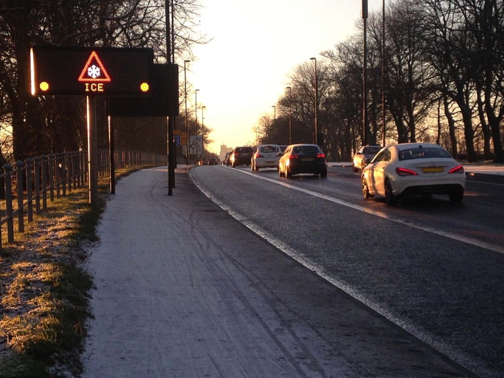 Picture of the Great North Road heading south from Gosforth showing a clear road and snow-covered pavement.