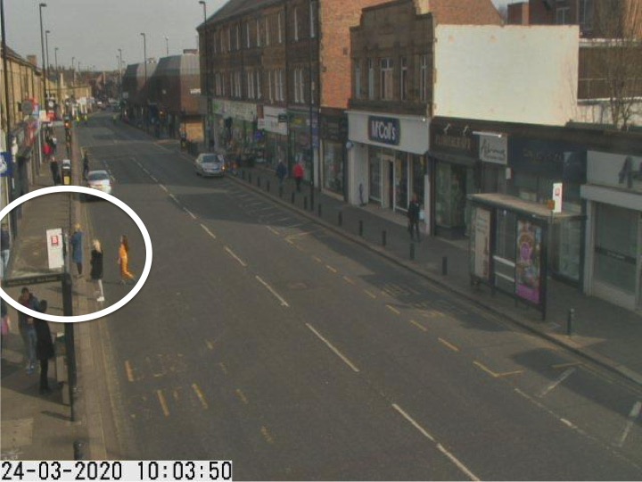 Traffic camera picture of Gosforth High Street with people waiting in the road for the cashpoint.