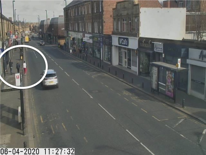 Traffic camera picture of Gosforth High Street with someone walking in the road.