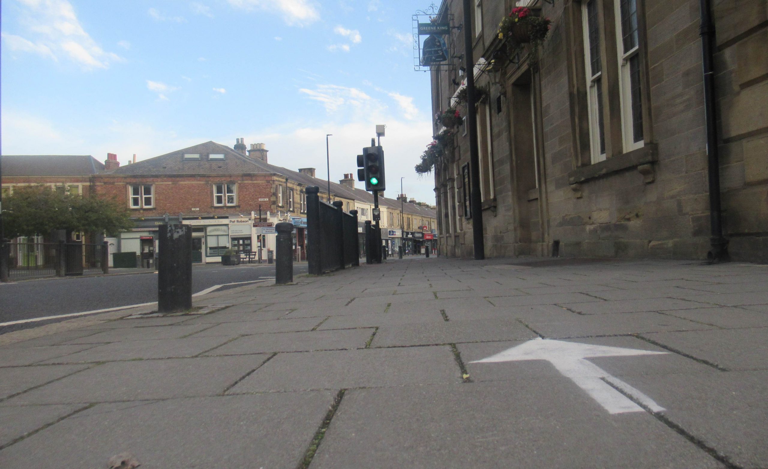 Picture of the pavement by The County with a painted direction arrow